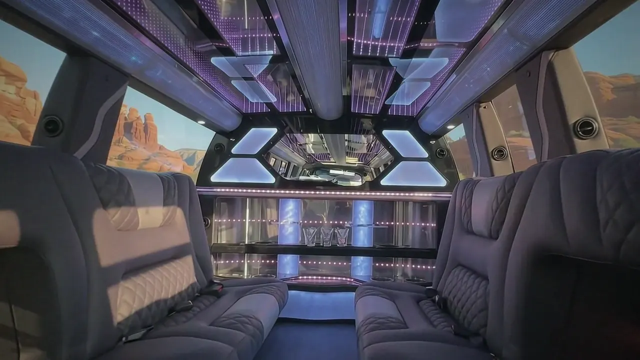 Inside the Cadillac Escalade limo in Pitkin County: LED light-show ceiling, leather lounge seating and lit bar